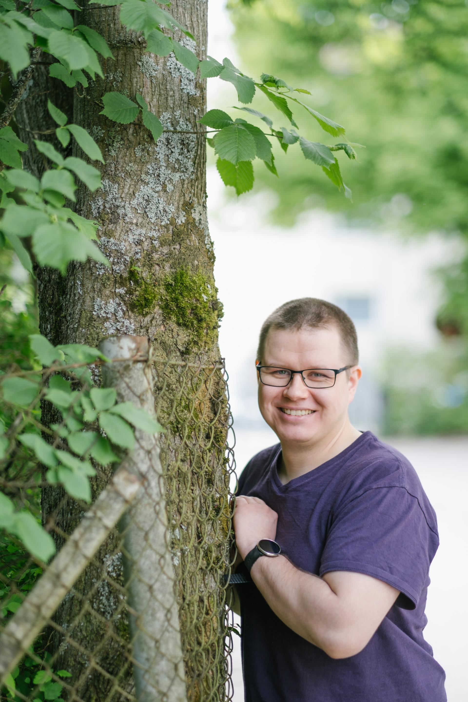 Esko-Jaakko lehti nojaa puuhun.