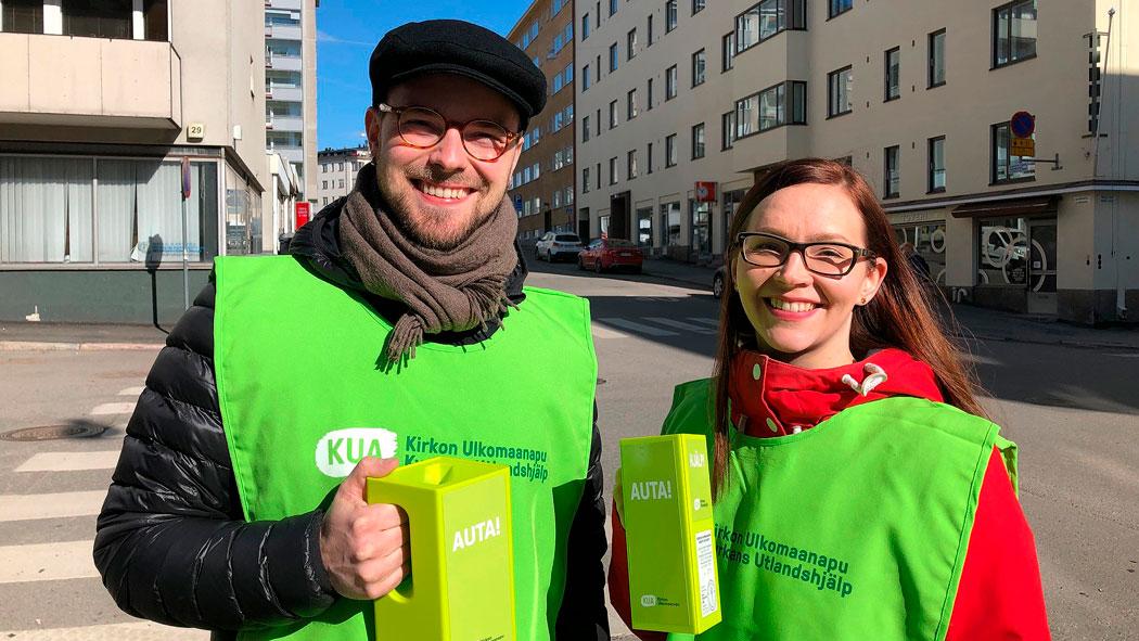 Kuvassa Antti Alanen ja Laura Pellikka KUA:n vihreät huomioliivit ja keräyslipas kädessään