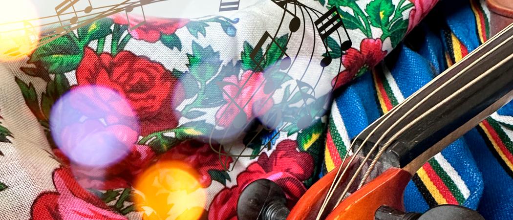 Kansallispuvun p&auml;&auml;ll&auml; viulu ja nuotteja.