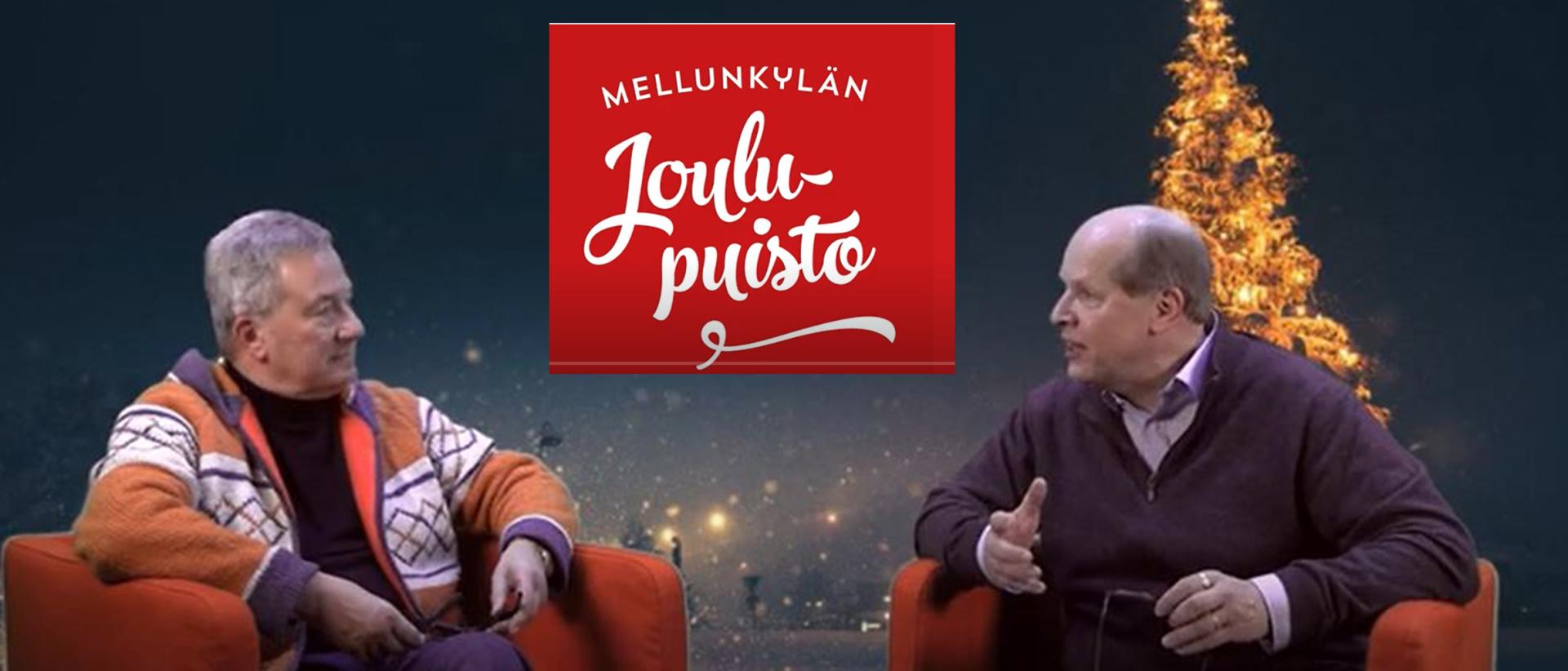 Juha Saunamäki ja Martti Häkkänen istumassa jouluvideossa jouluisalla taustalla. Kuvakaappaus videolta.