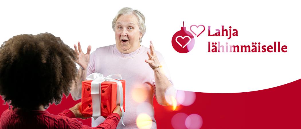Iloinen lahjan antaja ja saaja. Lahja lähimmäiselle keräyksen logo.