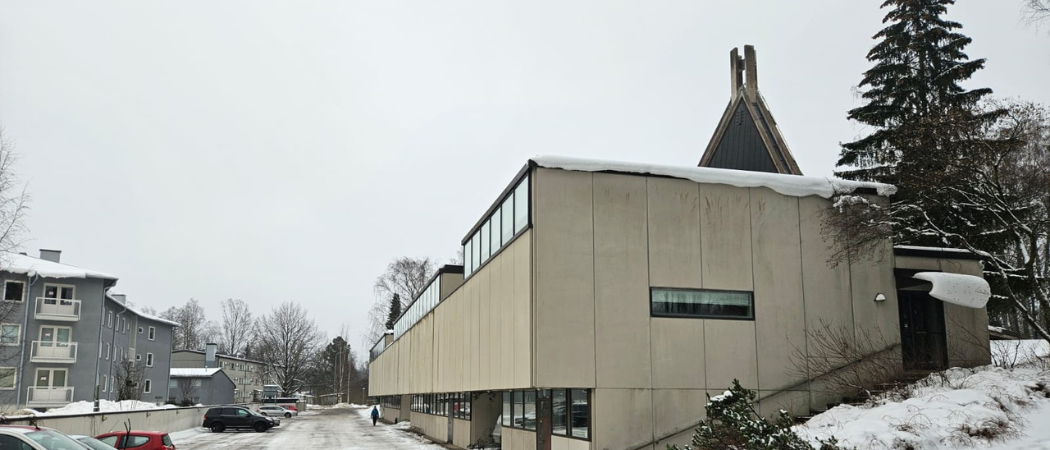 Kannelmäen seurakuntakeskus ja parkkipaikkaa harmaana talvipäivänä.