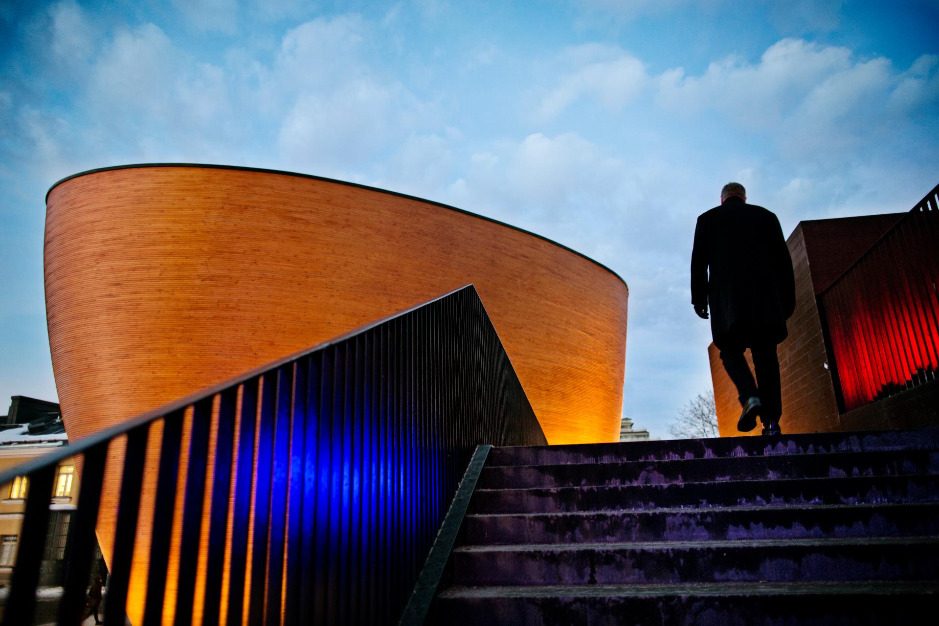 Man walking up the exterior stairs of Kamppi chapel